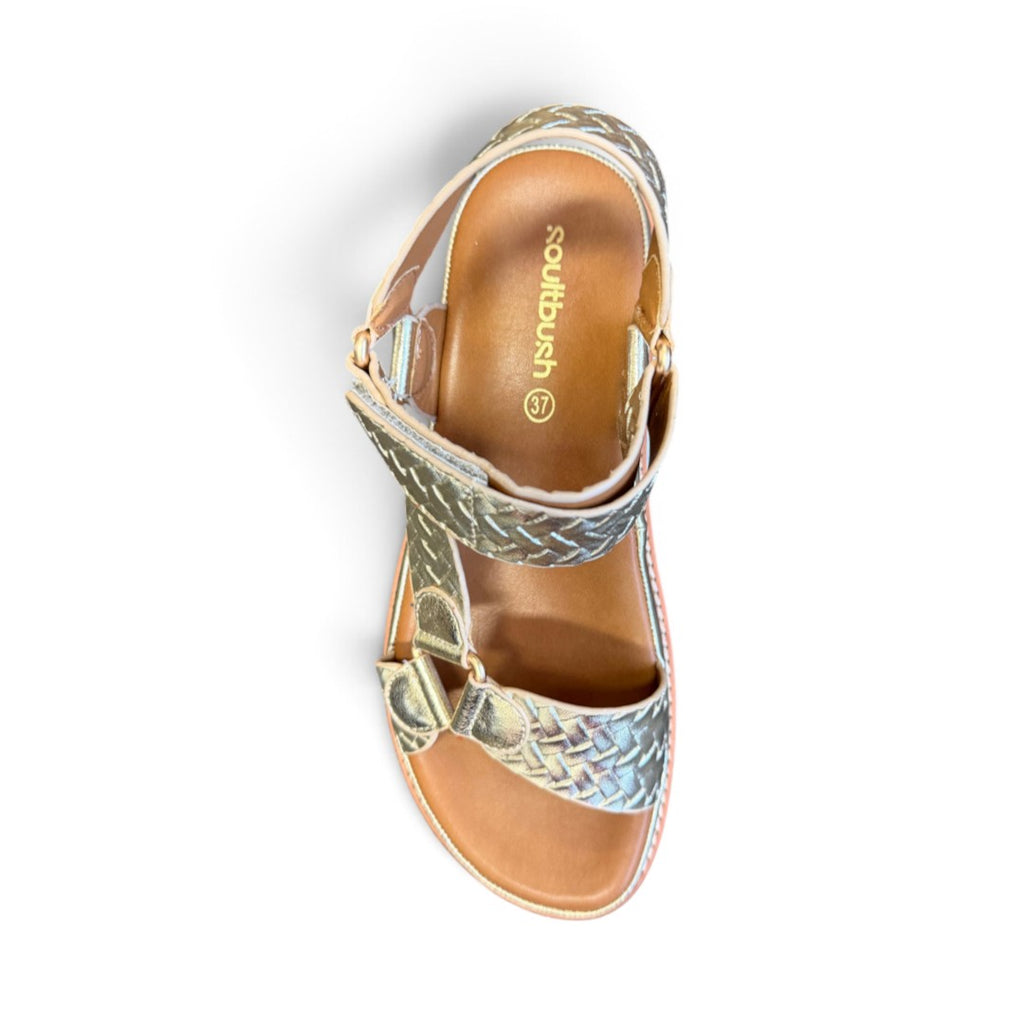 The Happy Shoe Shop Soultbush Harbour sandal in metallic gold with woven texture, Velcro strap, and tan footbed.