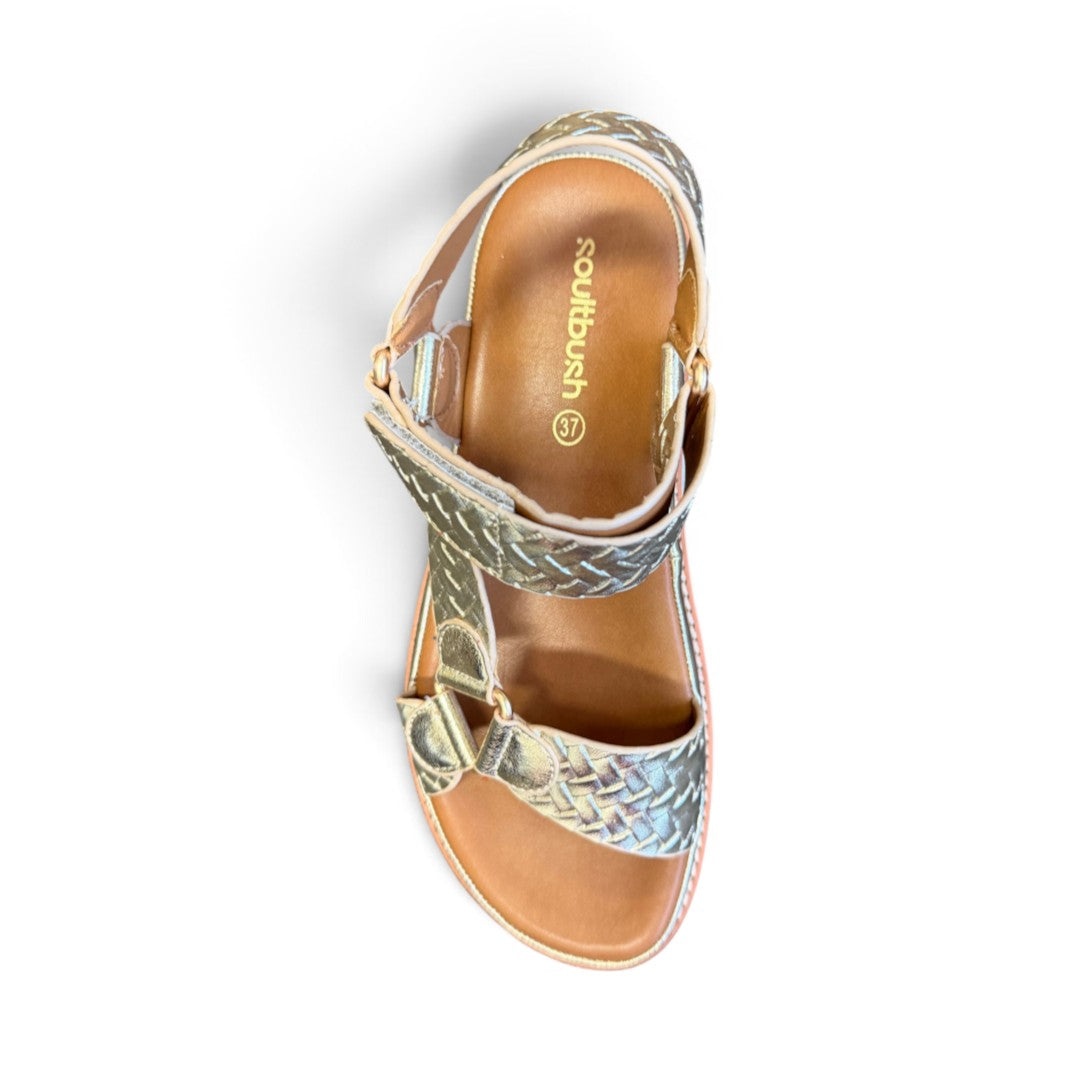 The Happy Shoe Shop Soultbush Harbour sandal in metallic gold with woven texture, Velcro strap, and tan footbed.