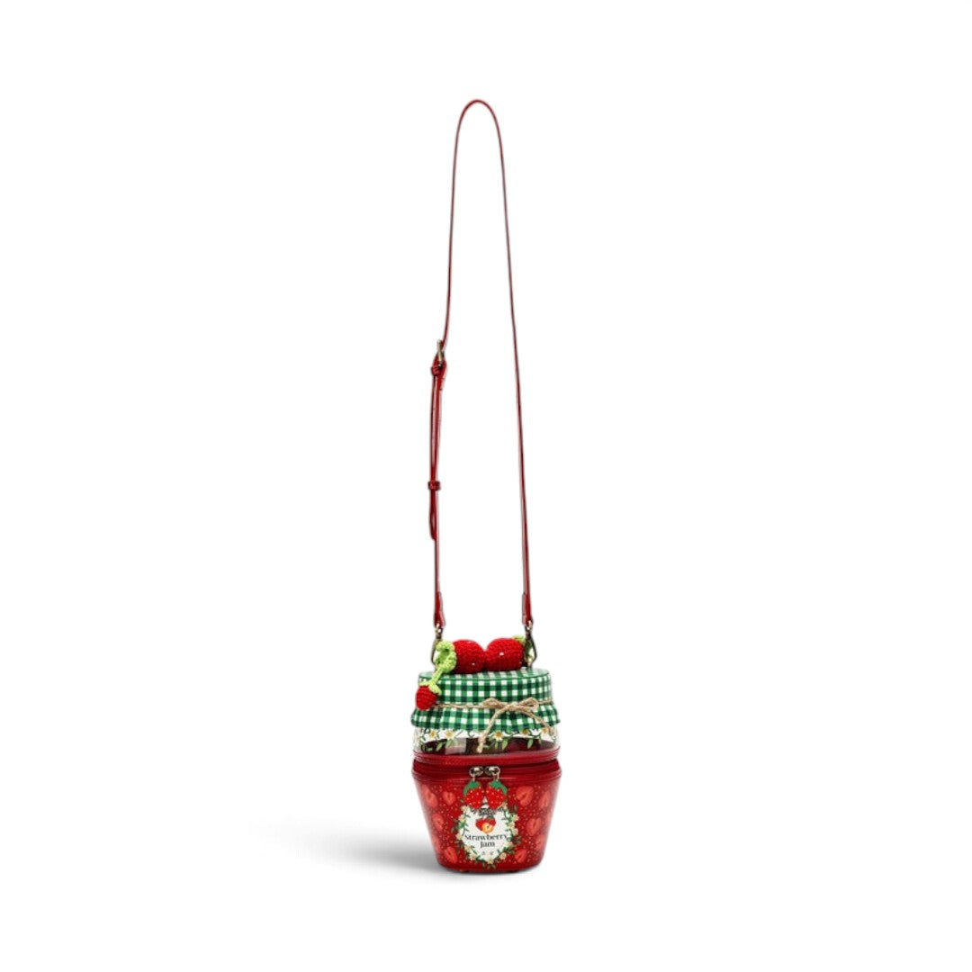 The Happy Shoe Shop Vendula London strawberry jam jar shaped crossbody bag in red and green vegan leather.
