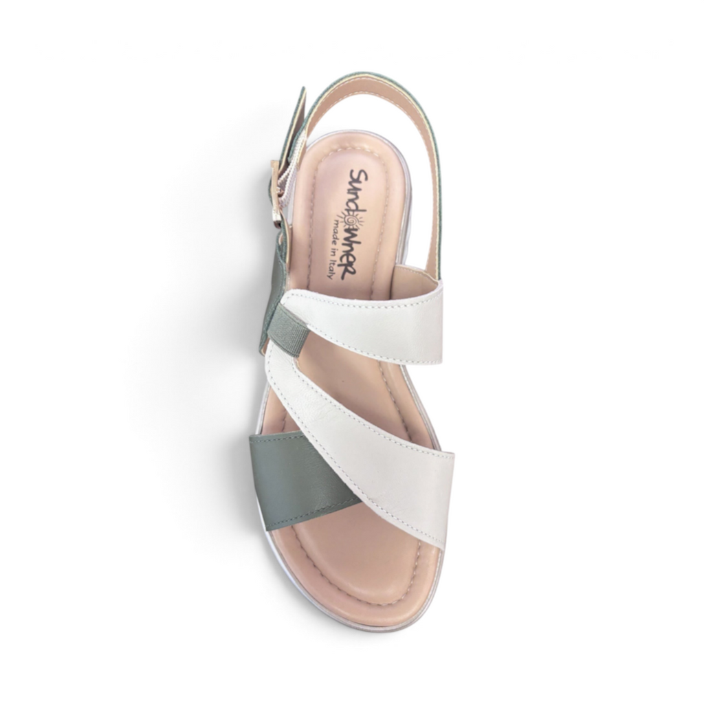 The Happy Shoe Shop Sundowner Satina sandal in white and sage green with a multi-strap design and buckle closure.