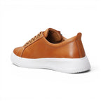 The Happy Shoe Shop Nelly tan leather sneakers with a white platform midsole and orthotic-friendly design.