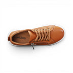 The Happy Shoe Shop tan leather Naked Arches Nelly sneakers with lace-up vamp, side zip, and white platform midsole.