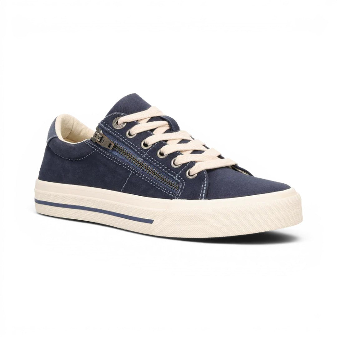 The Happy Shoe Shop Taos Z Soul navy blue canvas sneaker with side zipper, white laces, and rubber sole.