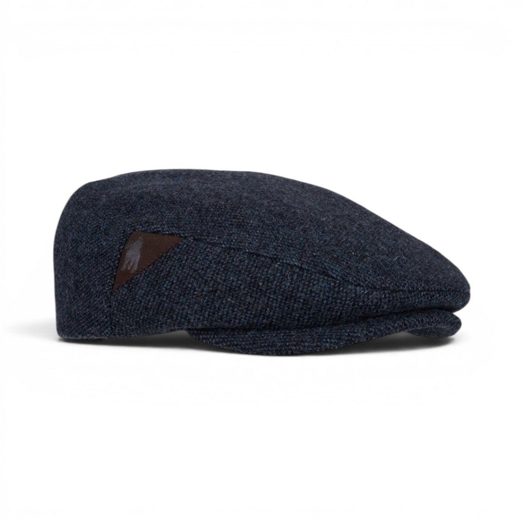 The Happy Shoe Shop Thomas Cook Samuel Driver Cap in navy blue wool with a brown leather logo detail.