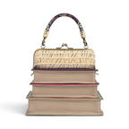The Happy Shoe Shop Vendula London book stack handbag with a concertina top, clip frame, and purple patterned handle.
