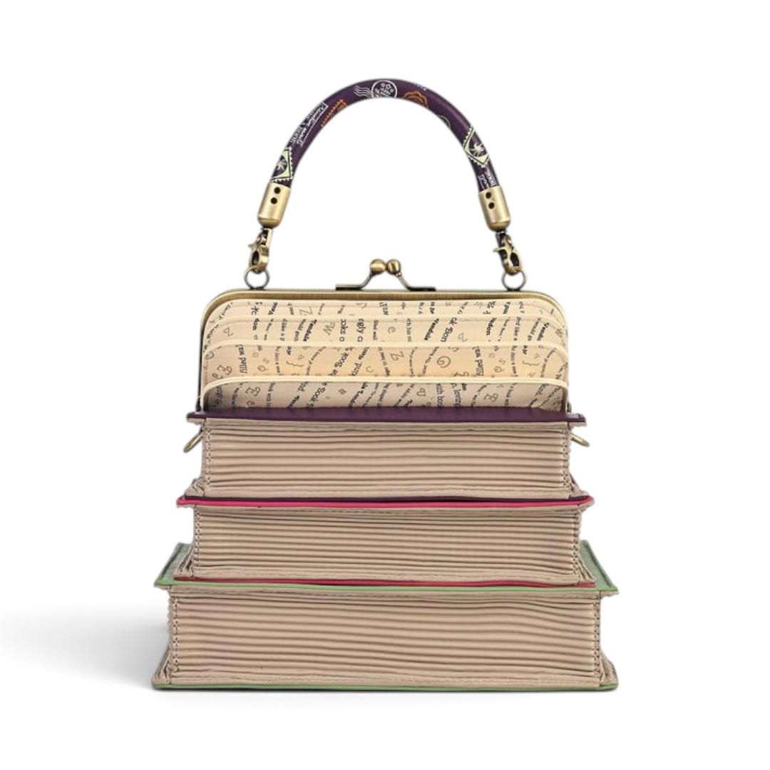 The Happy Shoe Shop Vendula London book stack handbag with a concertina top, clip frame, and purple patterned handle.