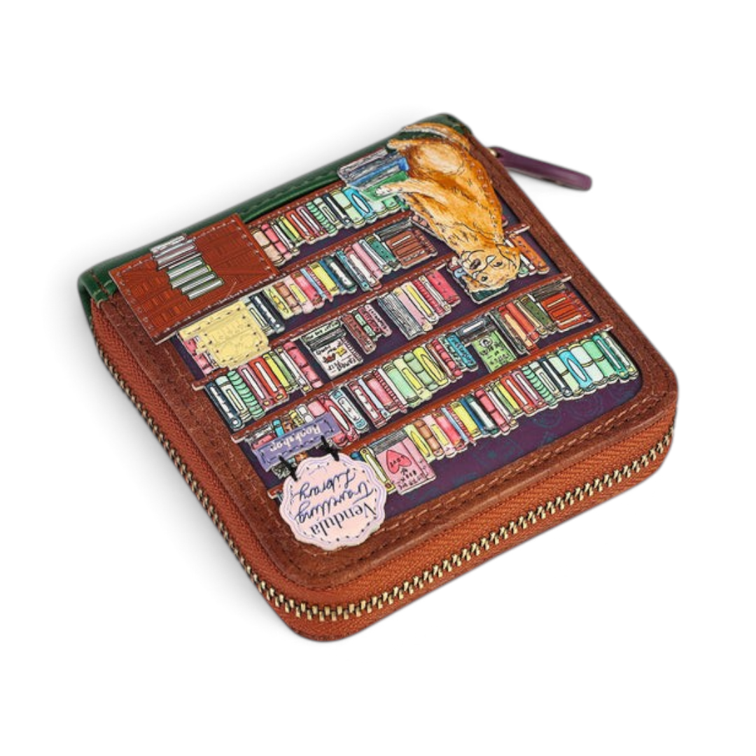 The Happy Shoe Shop Vendula London square wallet featuring a whimsical bookshop print with a cat on vegan leather.