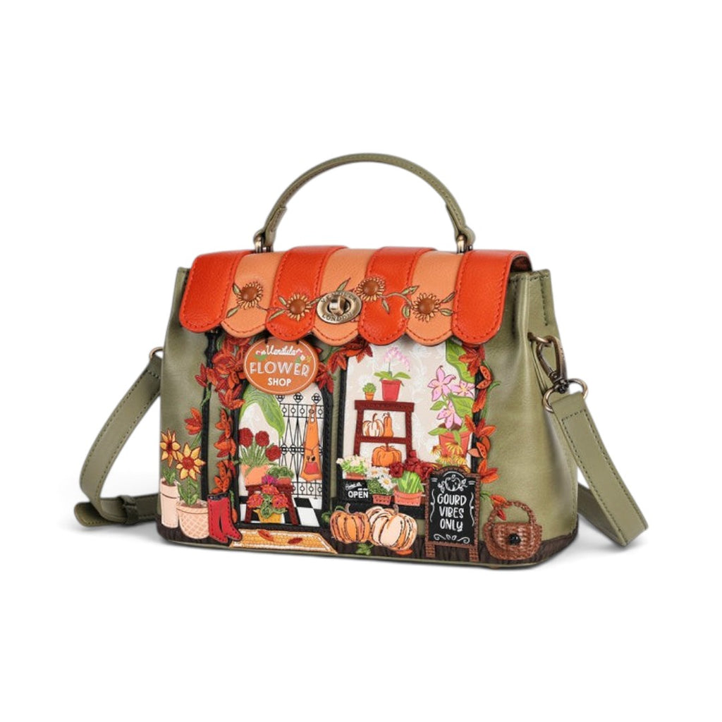 The Happy Shoe Shop Vendula London Flower Shop Mini Grace Bag in amber vegan leather with floral and shopfront details.