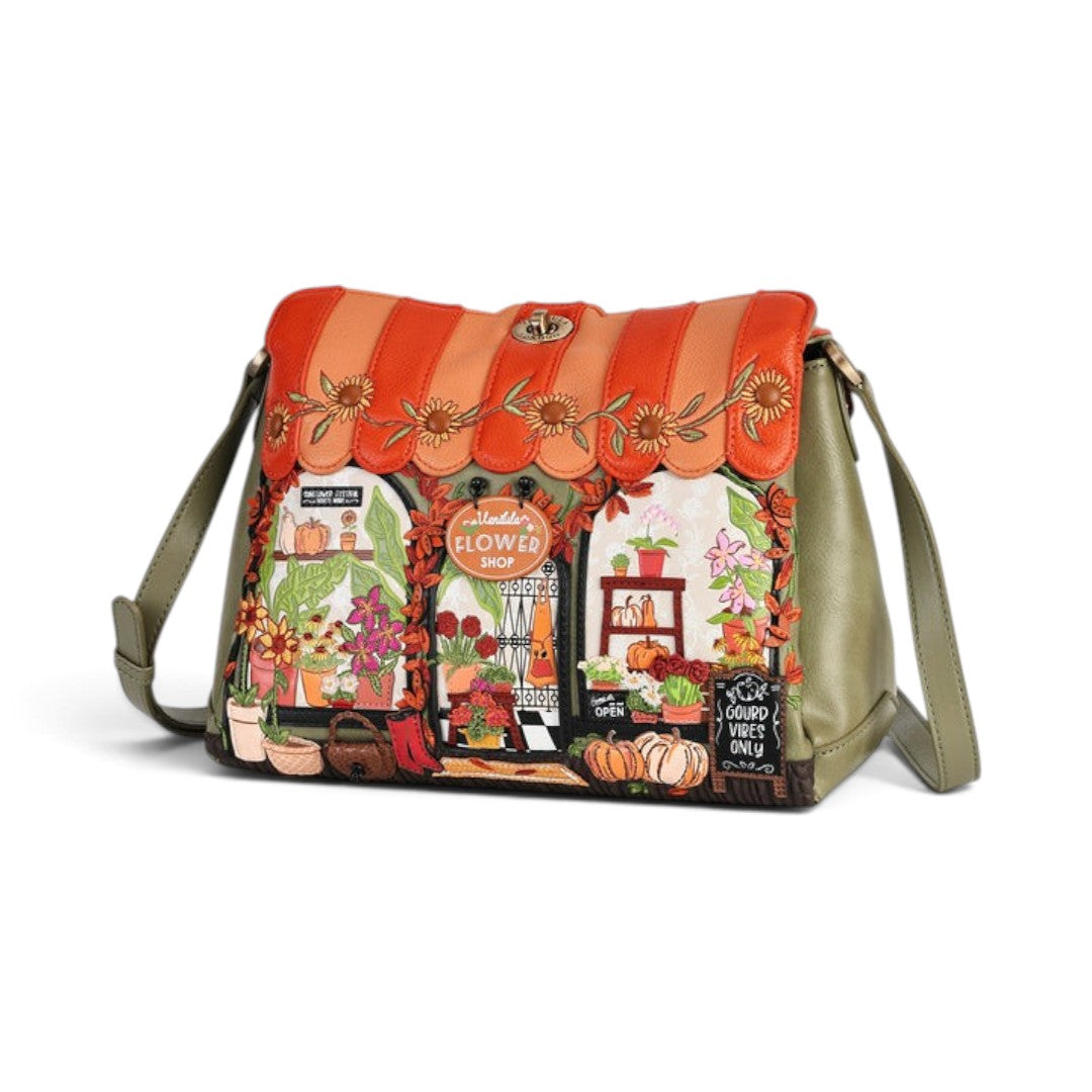 The Happy Shoe Shop Vendula Flower Shop Alice Bag in amber vegan leather with intricate floral appliqué and embroidery.
