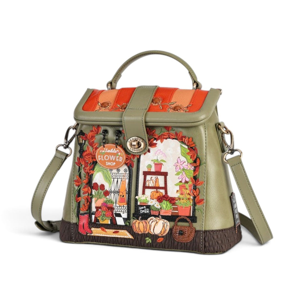 The Happy Shoe Shop Vendula London Lyla backpack in amber and olive vegan leather with flower shop themed embroidery.
