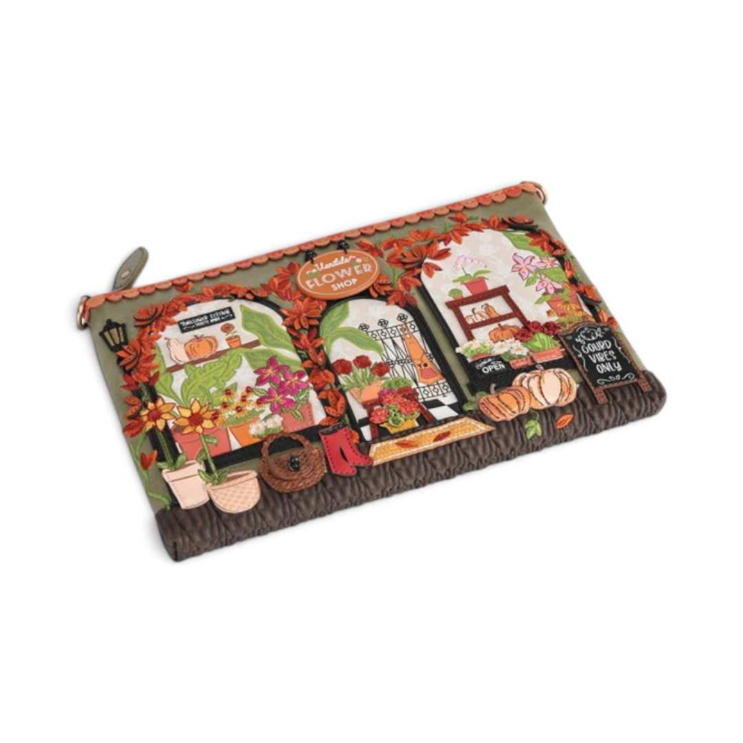 The Happy Shoe Shop Vendula London flower shop bag in amber vegan leather with intricate floral and shopfront details.