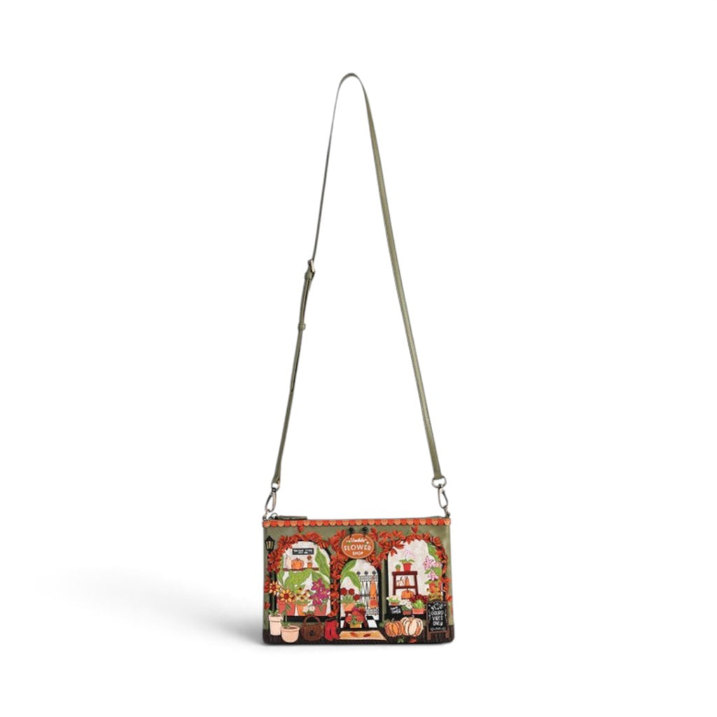 The Happy Shoe Shop Vendula London amber vegan leather flower shop crossbody bag with intricate floral shopfront design.