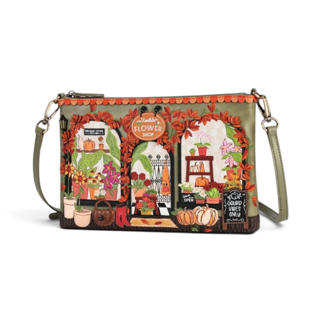 The Happy Shoe Shop Vendula London flower shop bag in amber vegan leather with intricate floral and shopfront details.