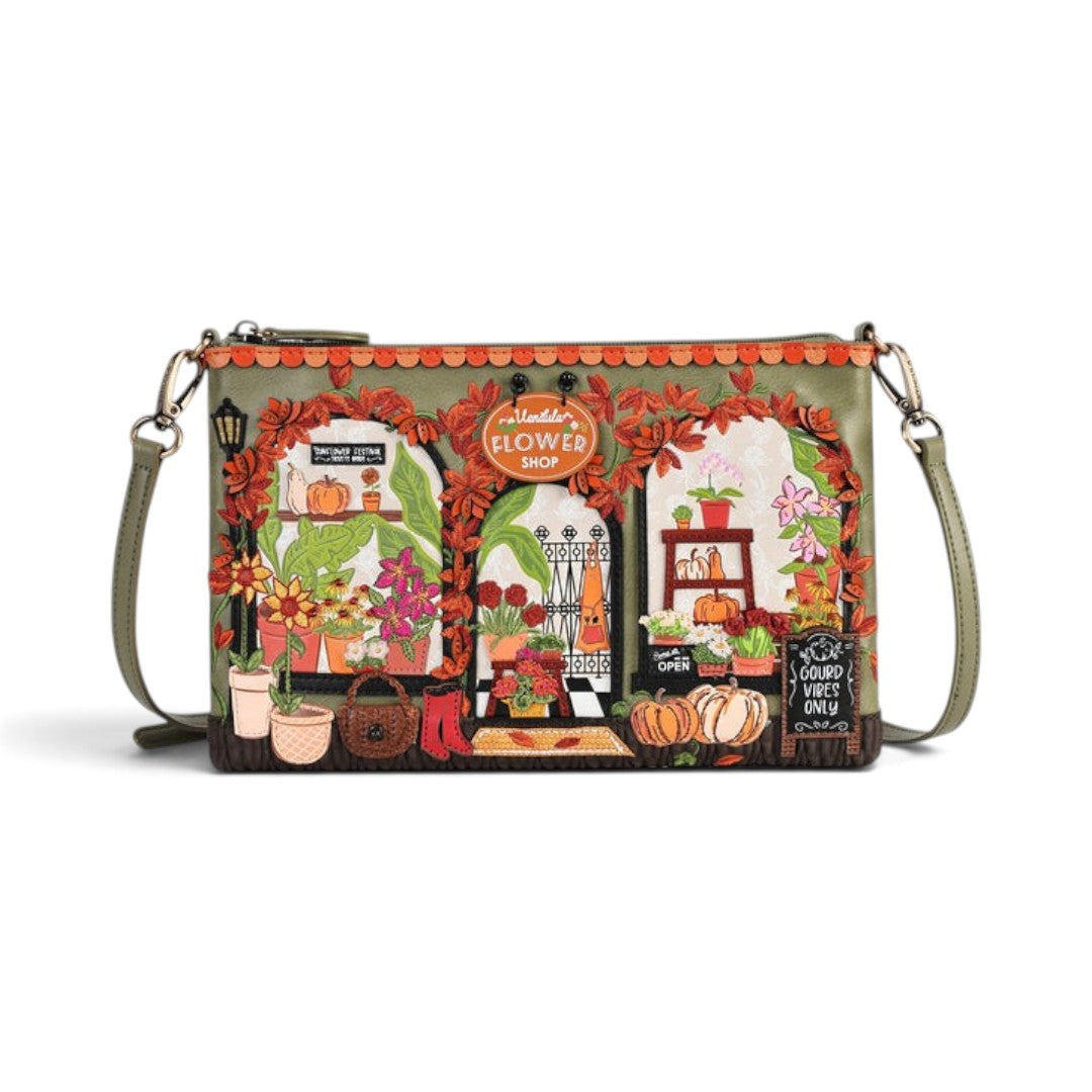 The Happy Shoe Shop Vendula London flower shop bag in amber vegan leather with intricate floral and shopfront details.