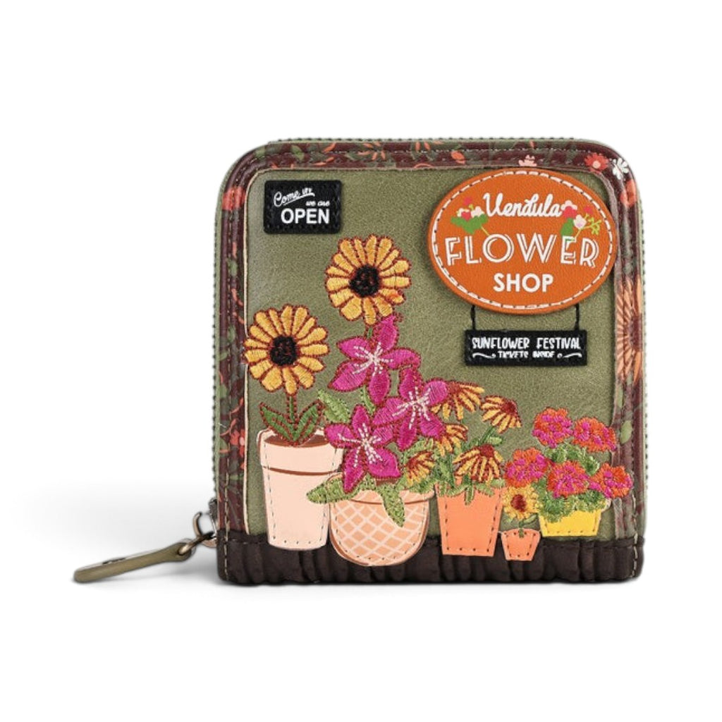 The Happy Shoe Shop Vendula London flower shop square wallet in amber with embossed floral and sunflower designs.