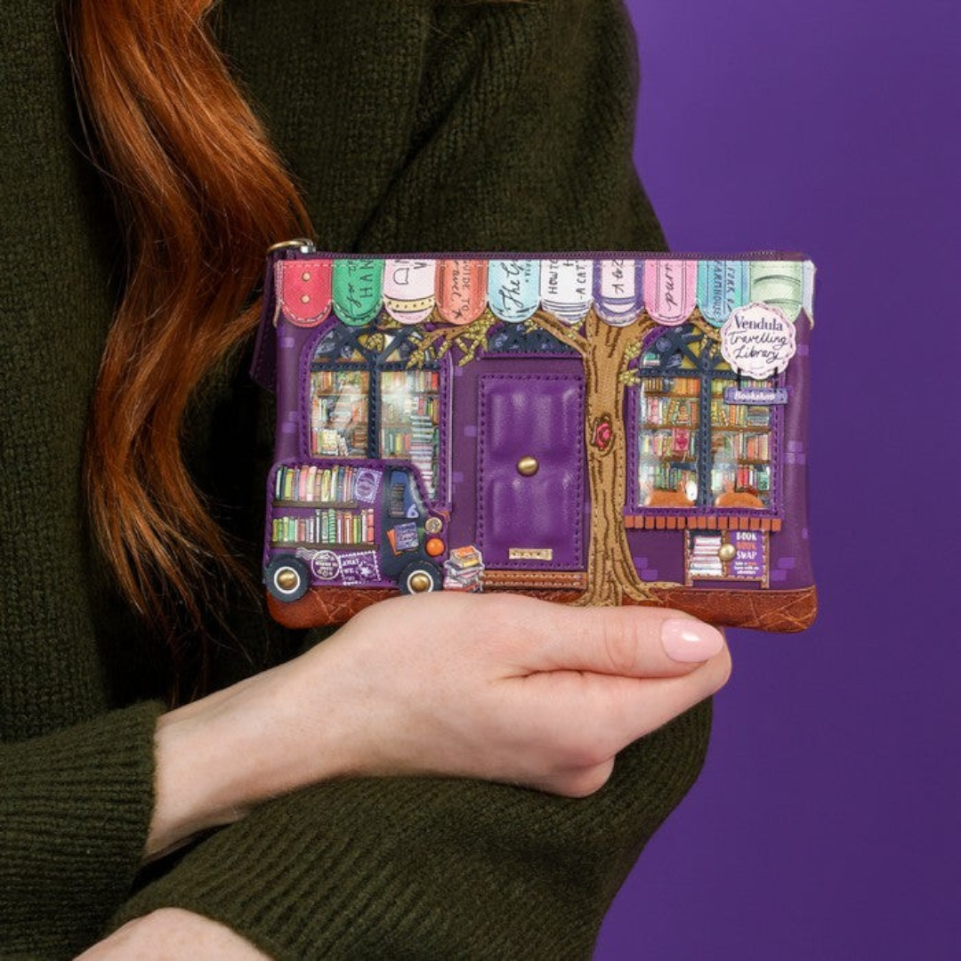 The Happy Shoe Shop Vendula London travelling library coin purse in purple vegan leather with detailed bookshop art.