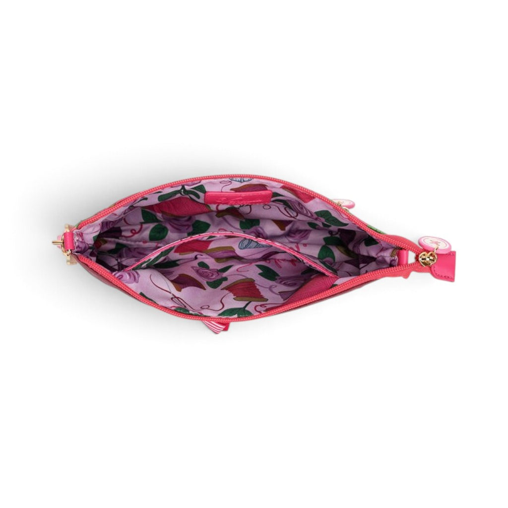 The Happy Shoe Shop Vendula London Kate bag interior showing pink fabric lining with sewing-themed print and pocket.