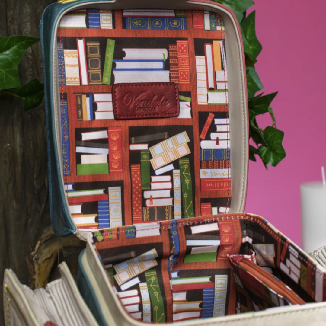 The Happy Shoe Shop Vendula London Book Stack Box Bag with a bookshelf print lining and vegan leather details.