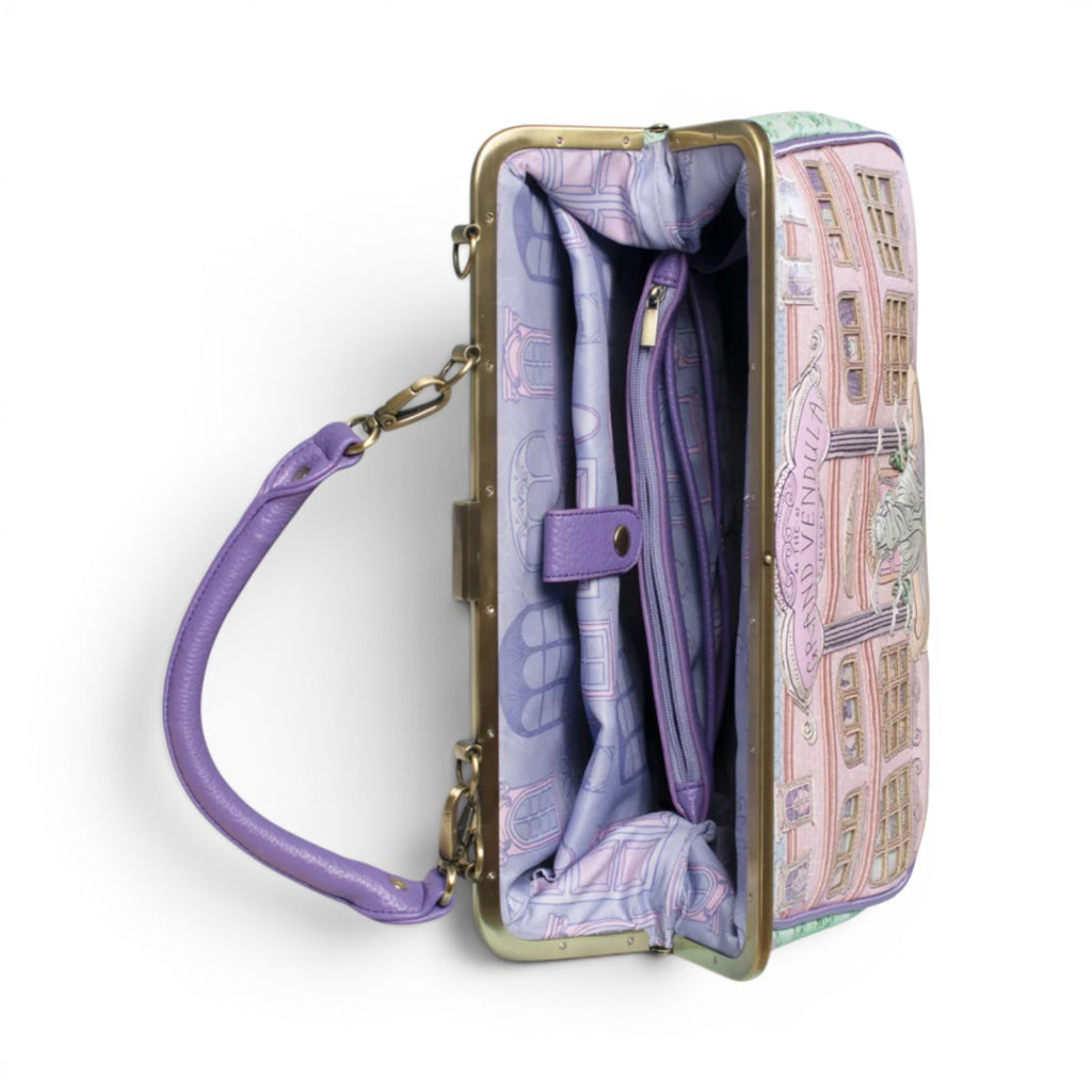 The Happy Shoe Shop Vendula London Grand Hotel Willow Clip Frame Bag in pink and green vegan leather with a vintage hotel facade design.