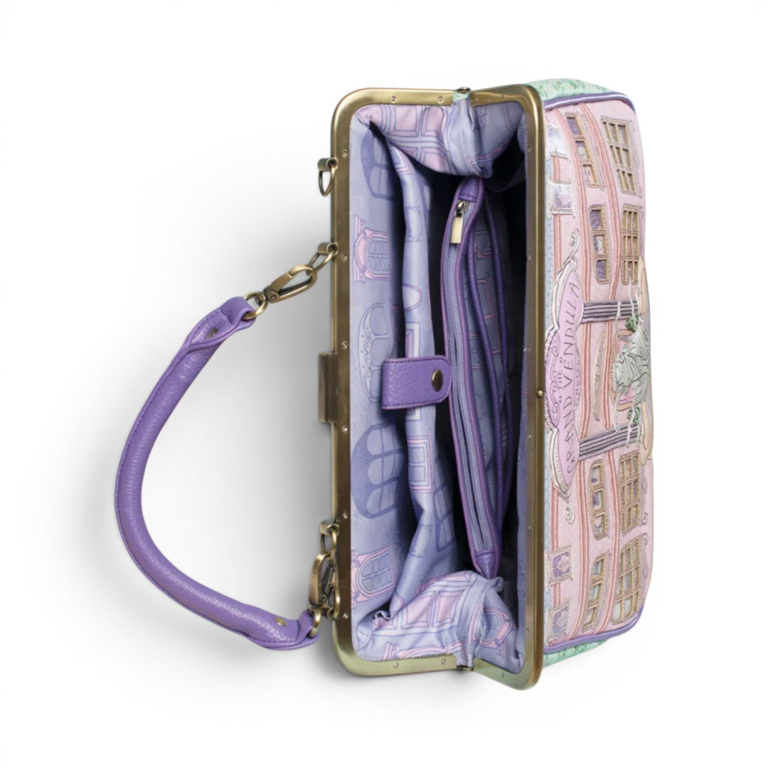 The Happy Shoe Shop Vendula London Grand Hotel Willow Clip Frame Bag in pink and green vegan leather with a vintage hotel facade design.