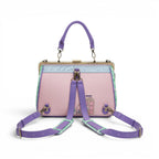 The Happy Shoe Shop Grand Vendula Hotel Willow Clip Frame Bag in pink vegan leather with purple straps and hotel design.