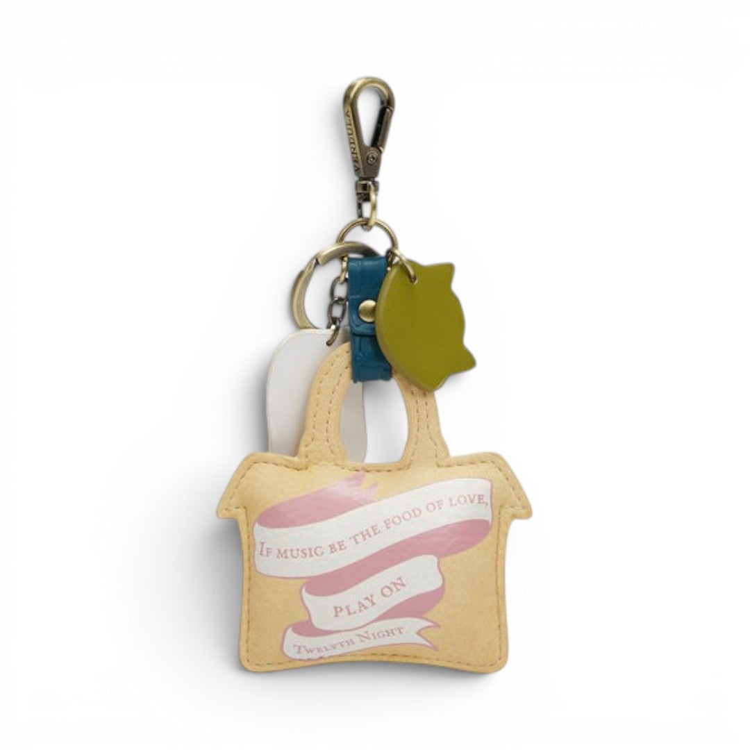 The Happy Shoe Shop Vendula London Shakespeare's Twelfth Night key charm in vegan leather, featuring a yellow tote bag design with a pink ribbon and text.