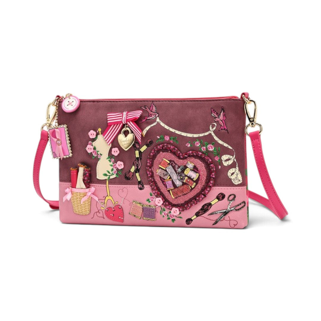 The Happy Shoe Shop Vendula London sewing box scrapbook bag in pink vegan leather with intricate craft-themed details.