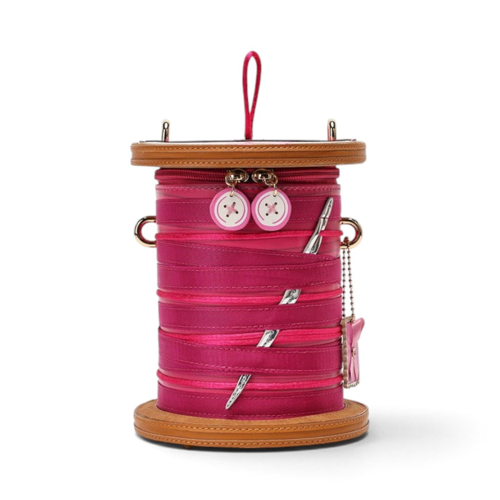 The Happy Shoe Shop Vendula London sewing box bag in raspberry vegan leather with ribbon and button details