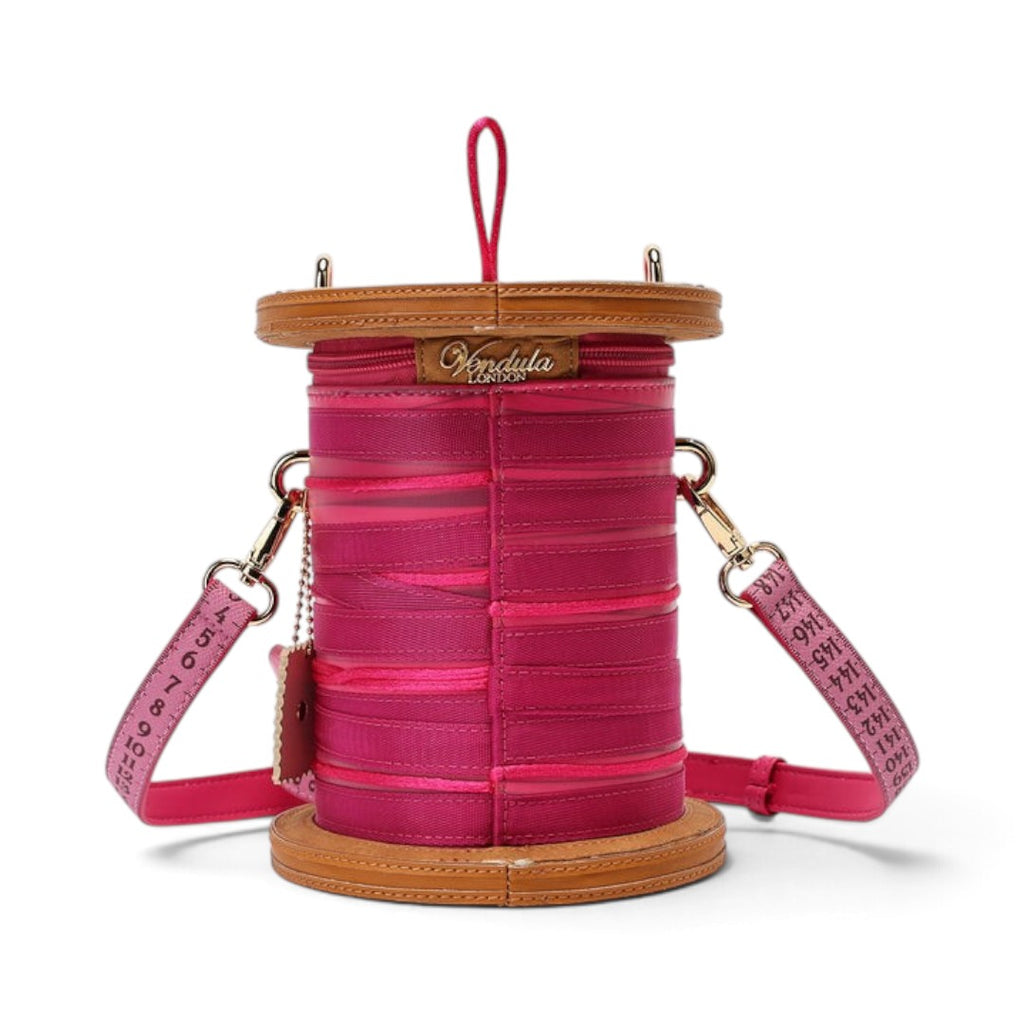 The Happy Shoe Shop Vendula London raspberry vegan leather sewing box bag with ribbon and measuring tape strap details.