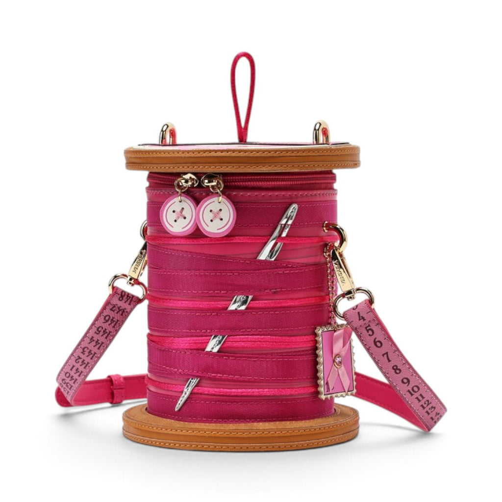 The Happy Shoe Shop Vendula London raspberry vegan leather sewing box bag with thread reel and button details.