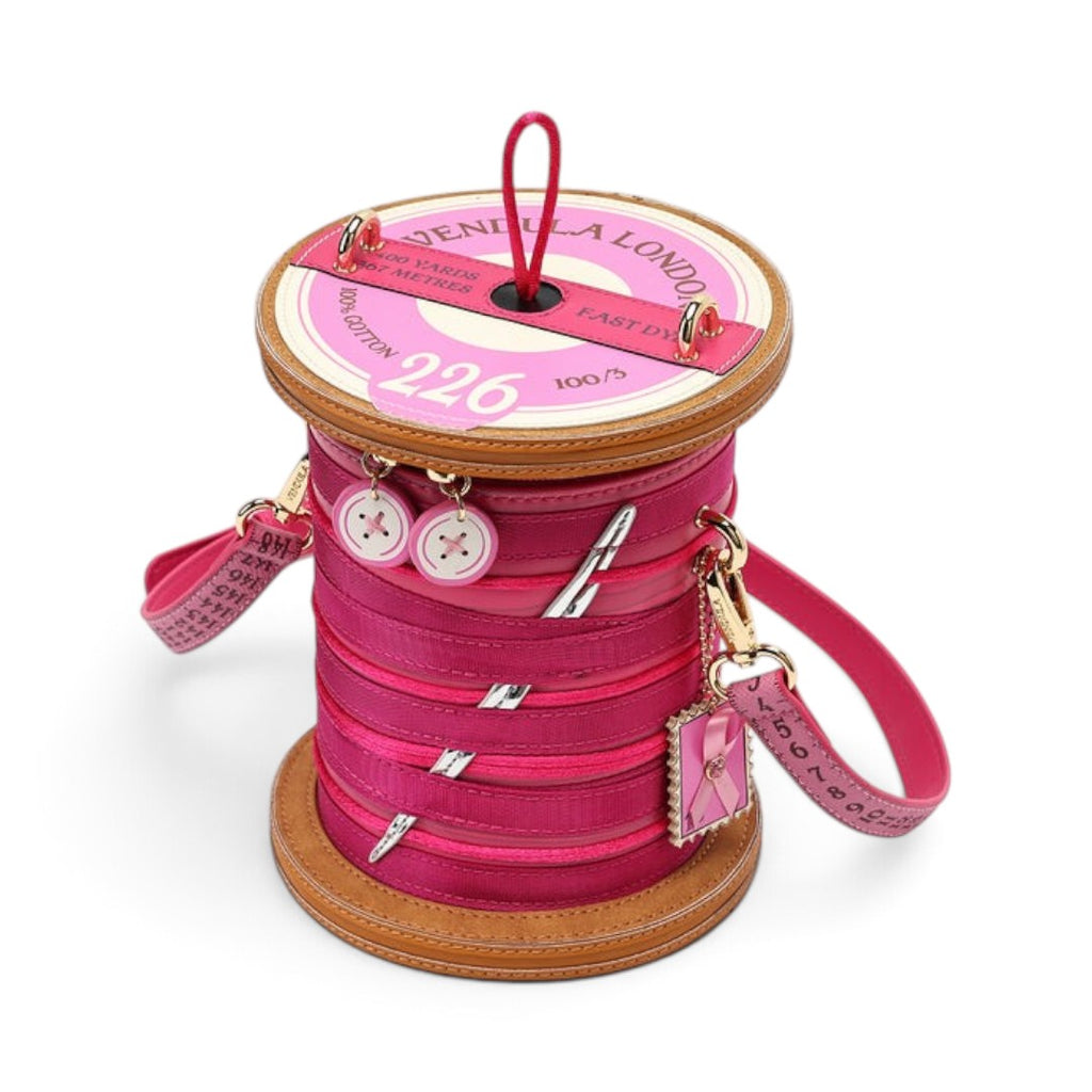 The Happy Shoe Shop Vendula London sewing box scrapbook reel bag in raspberry vegan leather with button charms.