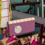 The Happy Shoe Shop Vendula London raspberry vegan leather ziparound wallet with sewing shop design and scalloped trim.