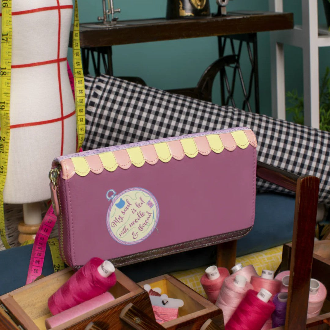 The Happy Shoe Shop Vendula London raspberry vegan leather ziparound wallet with sewing shop design and scalloped trim.