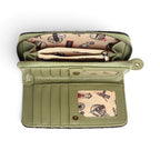 The Happy Shoe Shop Vendula London wallet interior showing sage green vegan leather, card slots, and patterned lining.