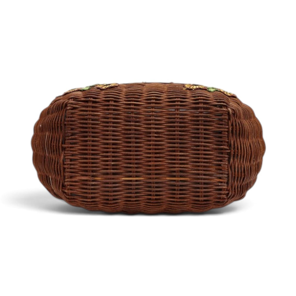 The Happy Shoe Shop Vendula London flower shop basket bag showing the brown woven wicker base from a bottom view.