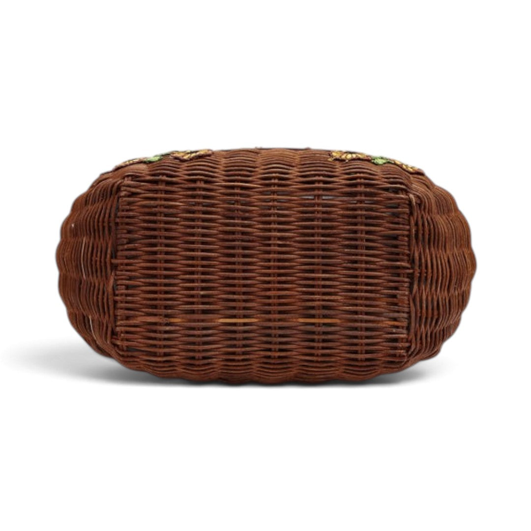 The Happy Shoe Shop Vendula London flower shop basket bag showing the brown woven wicker base from a bottom view.