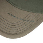 The Happy Shoe Shop Wrangler Fritz cap featuring olive green cotton fabric and contrast stitching on the curved peak.
